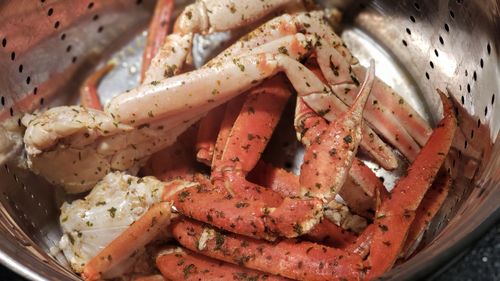 High angle view of crab legs in steamer pot