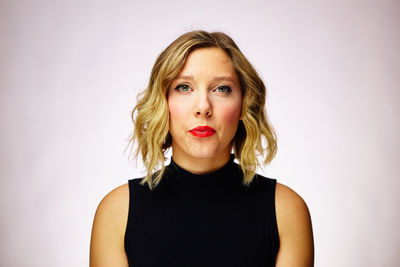 Portrait of beautiful young woman over white background