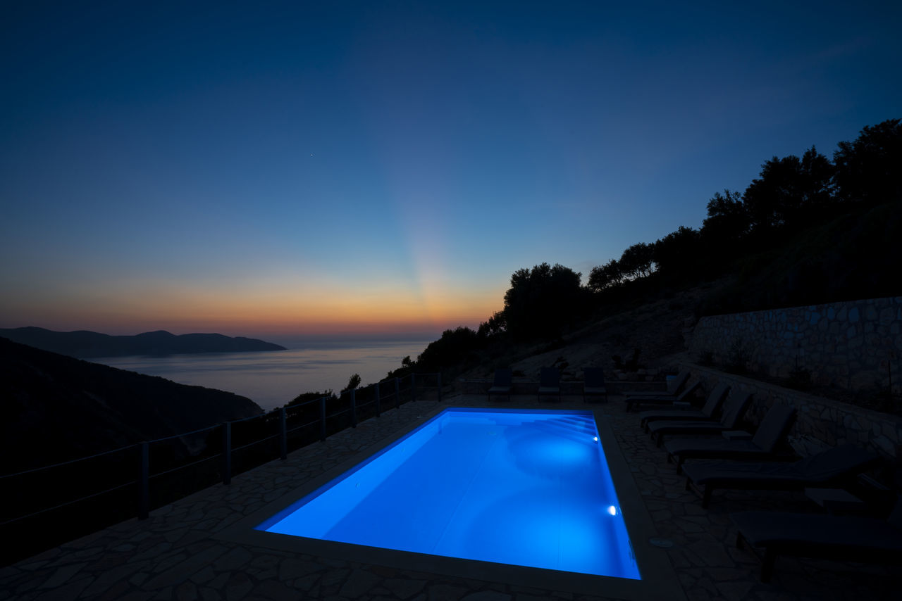 SCENIC VIEW OF SWIMMING POOL AGAINST CLEAR BLUE SKY