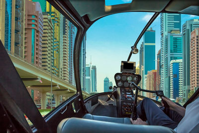 Digital composite image man flying helicopter amidst buildings in city