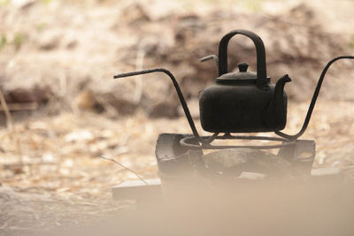 Close-up of old machine part on field