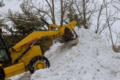 Yellow construction site on snow covered landscape