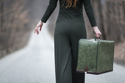 Midsection of woman holding book