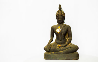 Statue of buddha against white background