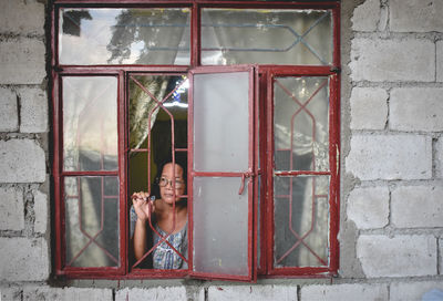 Woman looking through a window