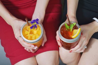 Midsection of women holding fresh ice teas