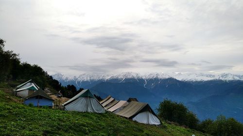 Houses on mountain against sky