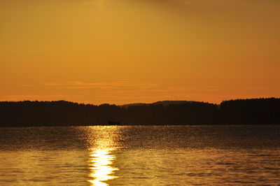 Scenic view of lake at sunset