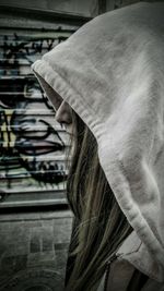 Side view of woman in hooded jacket