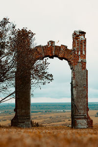 Old ruin by sea against sky