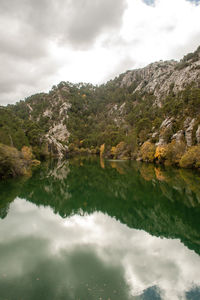 Scenic view of lake and mountains against sky