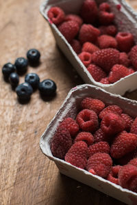 Close-up of raspberries in containers on table