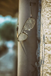 Close-up of water drops on metal against wall