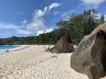 People on beach against sky