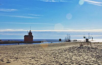 Scenic view of beach against cloudy sky