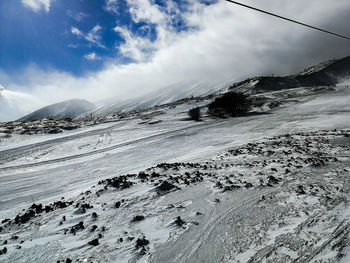 Scenic view of snow covered mountains against sky