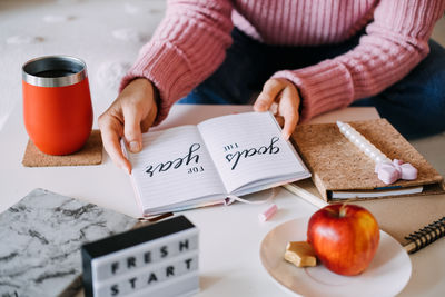 Midsection of woman holding christmas decoration