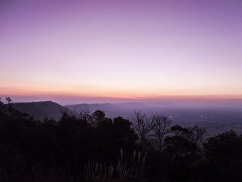 Scenic view of silhouette mountains against sky at sunset