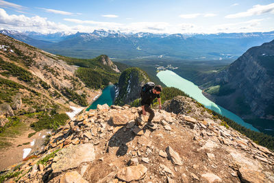 Hiker climbing up devil's thumb peak in lake louise banff