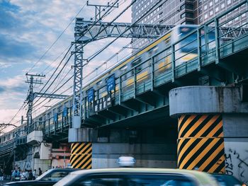 Low angle view of bridge against sky in city
