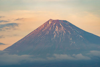 Scenic view of volcano against sky during sunset