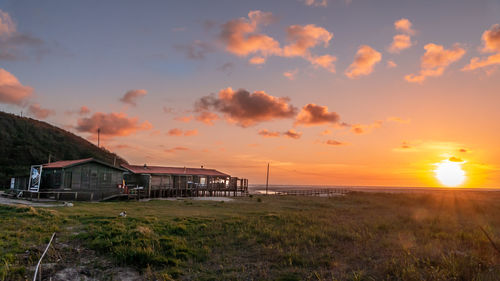 Scenic view of beach against sky during sunset