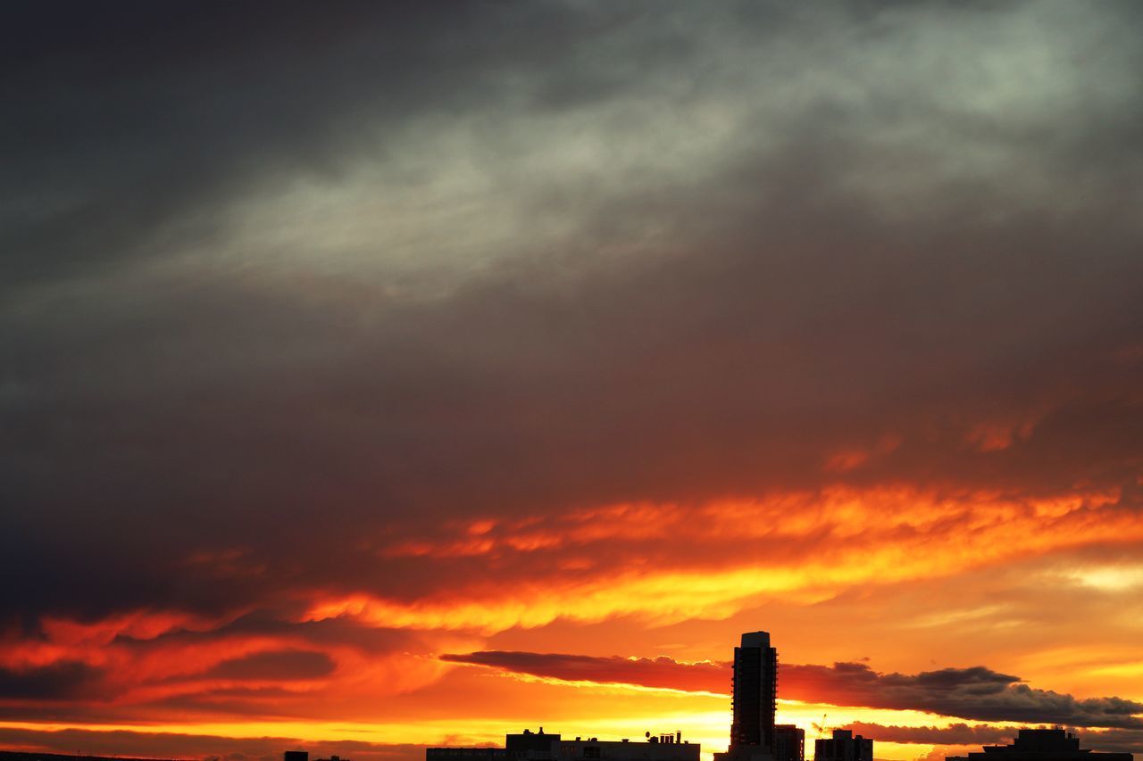 LOW ANGLE VIEW OF SILHOUETTE FACTORY AGAINST DRAMATIC SKY