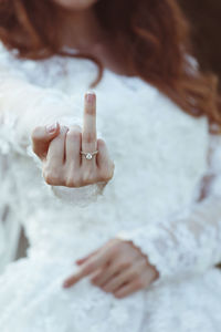 Close-up of bride showing ring finger