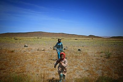 Woman standing on grassy field