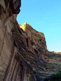 Low angle view of rock formations against blue sky