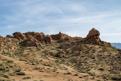 Rock formations on landscape against sky