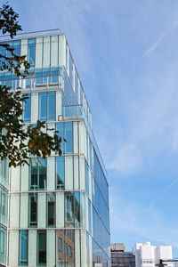 Low angle view of modern building against blue sky