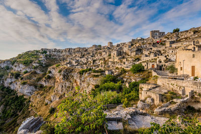 Houses on mountain at sassi di matera against blue sky