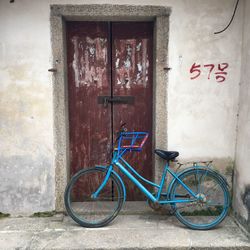 Bicycle parked against wall