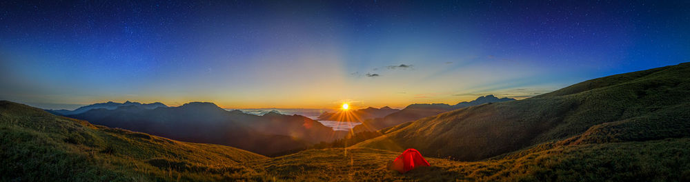 Scenic view of mountains against sky at night