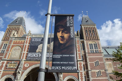 Low angle portrait of young man standing against building in city