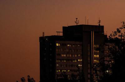 Low angle view of illuminated building against sky at dusk