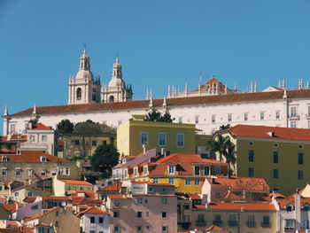 Buildings in town against clear sky