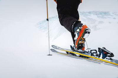 Close-up of freeride ski boots on snow. skitour concept. used worn boots on a male skier against the