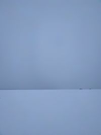 Scenic view of snow against clear blue sky