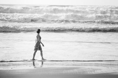 Full length of woman walking on beach