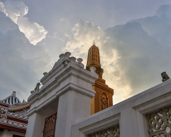 Low angle view of building against cloudy sky