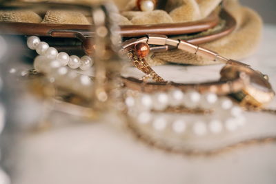 Close-up of jewelry by purse on table