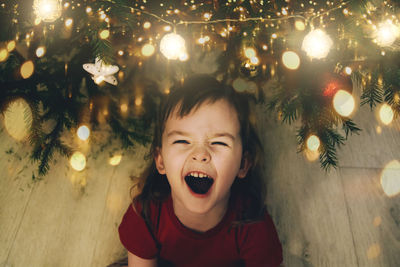 Cheerful child girl waiting for merry christmas and miracles