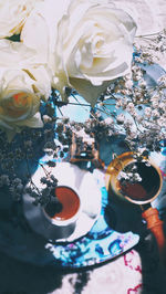 High angle view of roses in vase on table