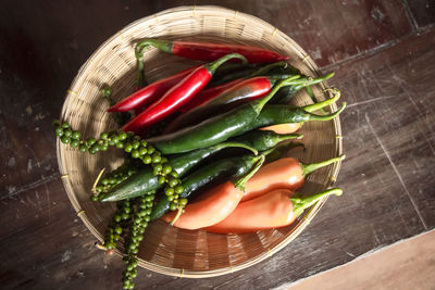 High angle view of chili peppers in basket on table