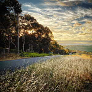 Scenic view of land against sky during sunset