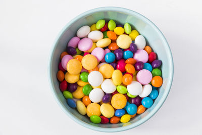 Colorful candies in the bowl, all color candies, white background