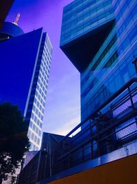 Low angle view of modern building against cloudy sky