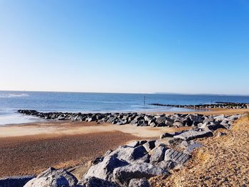 Scenic view of sea against clear blue sky